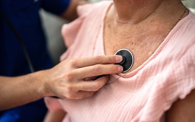 close up of doctor using stethoscope
