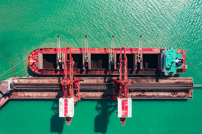 在港口卸载金属矿石的散货船图片下载