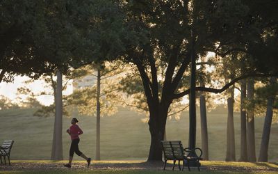 Woman running in park at dusk