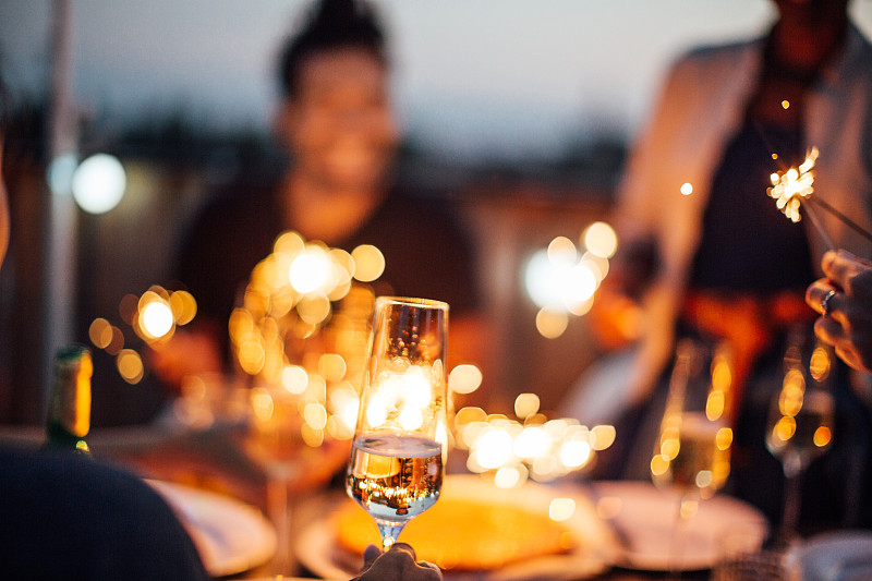 朋友们享受着香槟和烟花的屋顶派对图片下载