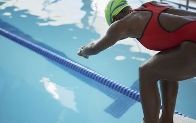 Swimmer at ready to dive into pool